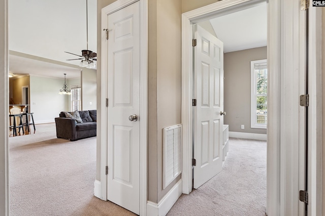 hallway featuring light carpet