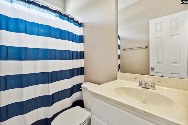 bathroom featuring vanity, toilet, and walk in shower