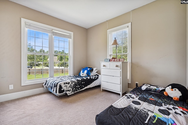 carpeted bedroom featuring multiple windows