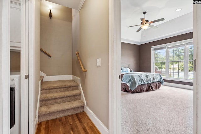 bedroom featuring ceiling fan, wood-type flooring, and washer / clothes dryer