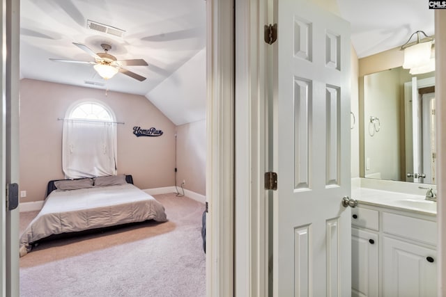 bedroom featuring sink, vaulted ceiling, light colored carpet, and ceiling fan