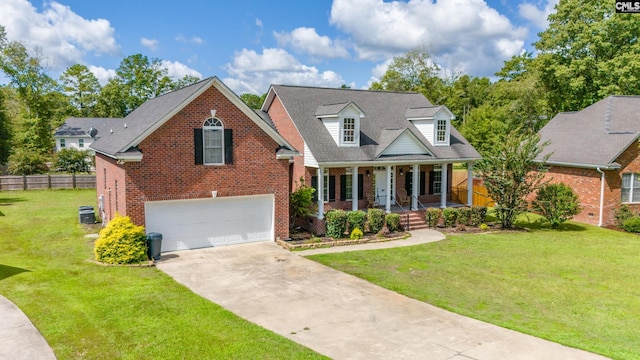 view of front of property featuring a front yard, a garage, cooling unit, and a porch