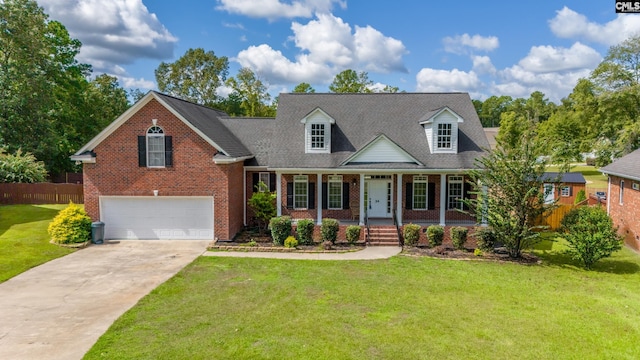 new england style home featuring a porch, a front lawn, and a garage