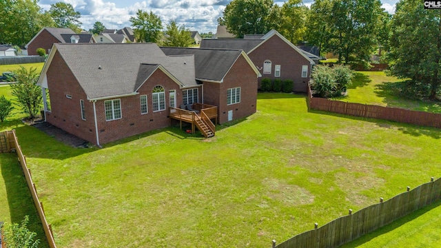 back of house with a wooden deck and a lawn