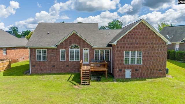 back of house featuring a yard and a wooden deck