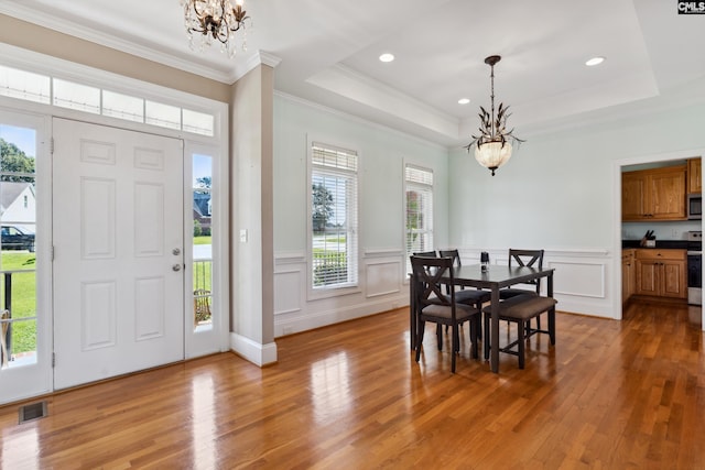 foyer featuring light hardwood / wood-style flooring, an inviting chandelier, and plenty of natural light