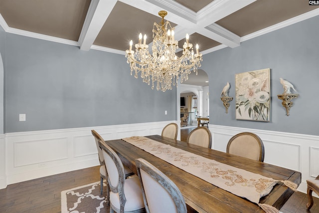 dining room with beam ceiling, an inviting chandelier, crown molding, and dark wood-type flooring