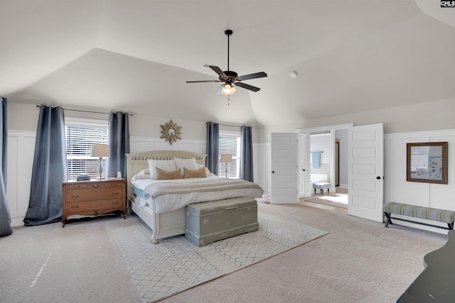 bedroom featuring ceiling fan, light colored carpet, vaulted ceiling, and multiple windows