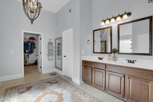 bathroom featuring a chandelier, tile patterned flooring, and vanity