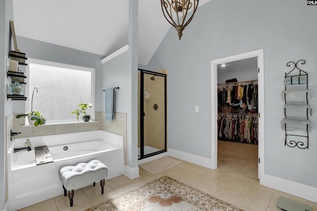 bathroom with vaulted ceiling, independent shower and bath, and tile patterned floors