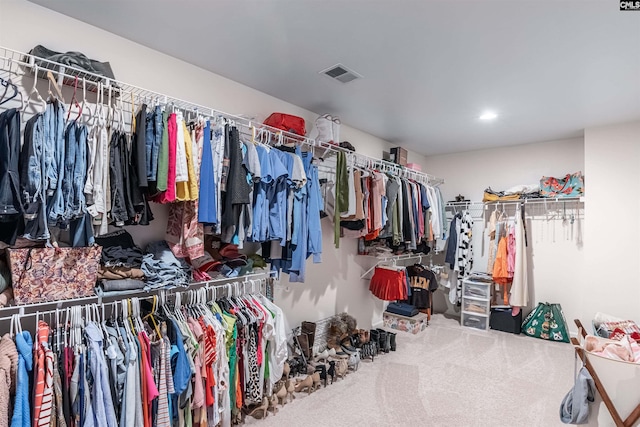 walk in closet featuring carpet floors