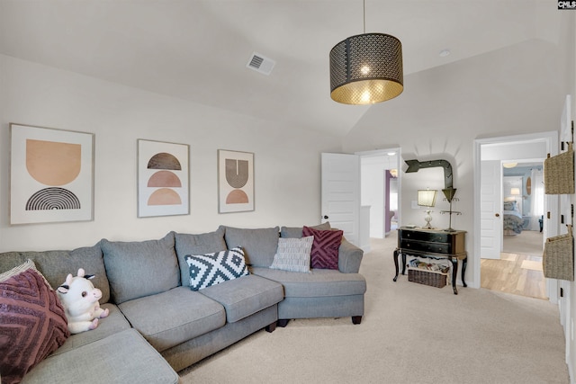 carpeted living room featuring lofted ceiling