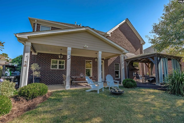 back of property featuring a gazebo, a lawn, and a patio