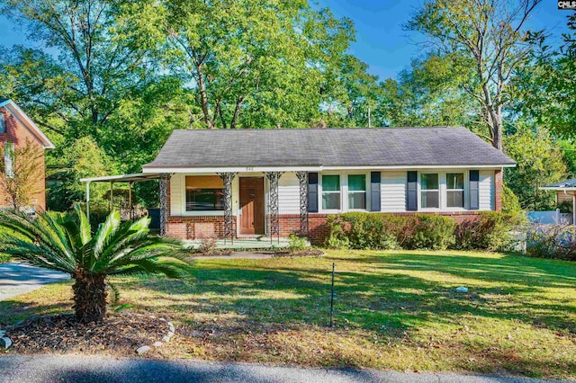 view of front of home with covered porch and a front lawn