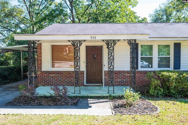 view of front of house featuring a carport and a porch