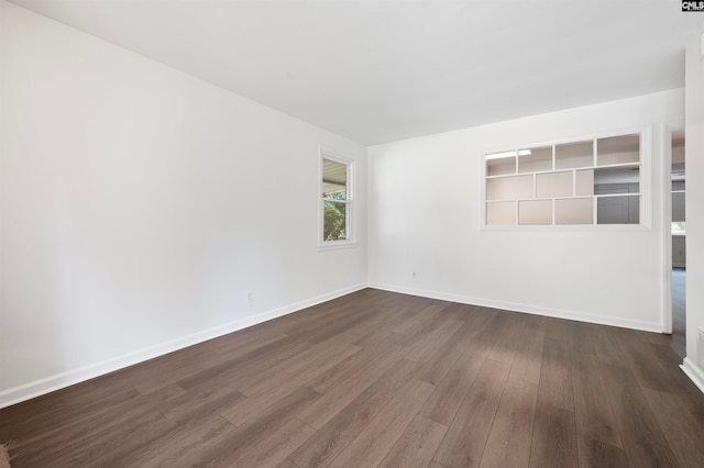 spare room featuring dark wood-type flooring