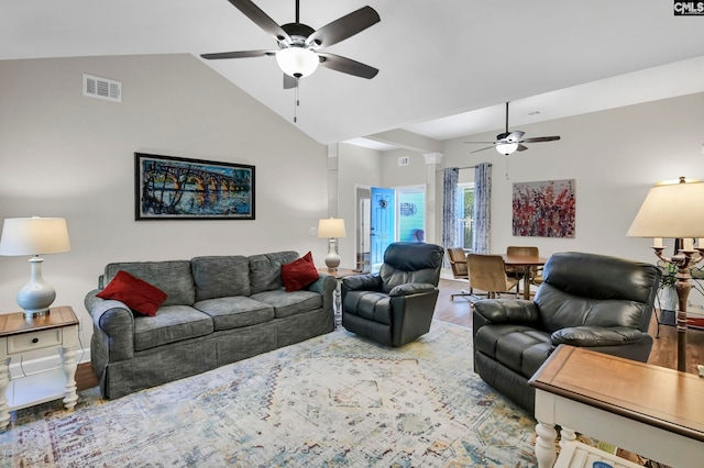 living room featuring hardwood / wood-style floors, high vaulted ceiling, and ceiling fan