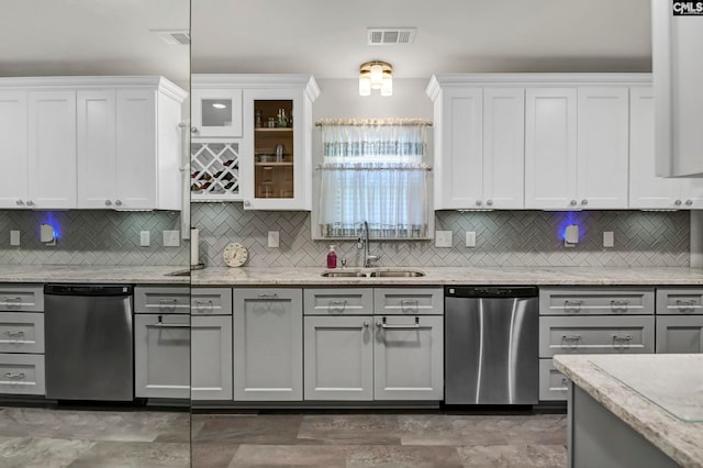 kitchen featuring sink, tasteful backsplash, and dishwasher