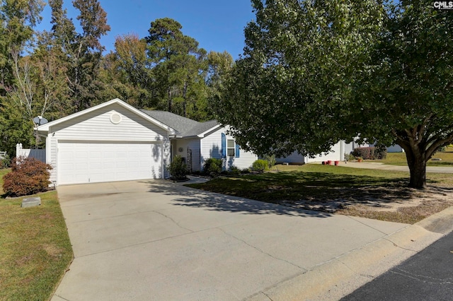 view of front of house featuring a garage and a front lawn