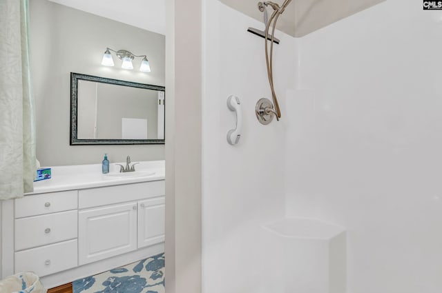 bathroom with vanity, hardwood / wood-style floors, and walk in shower