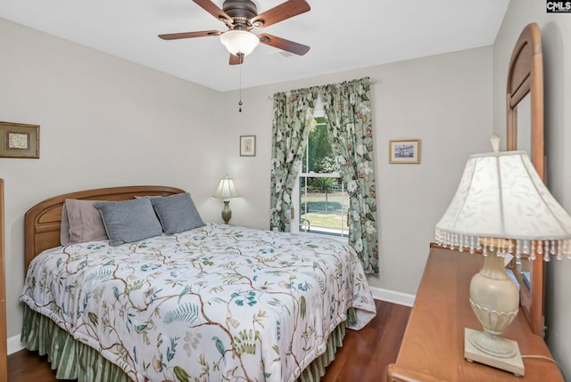 bedroom with dark hardwood / wood-style flooring and ceiling fan