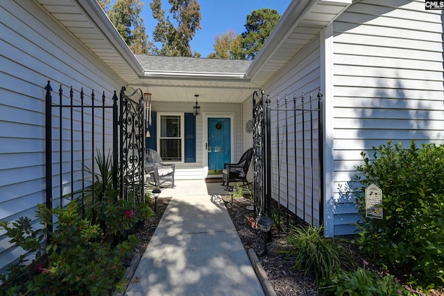 view of exterior entry featuring a porch