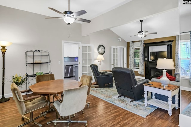 living room with dark wood-type flooring, ceiling fan, lofted ceiling, and a fireplace