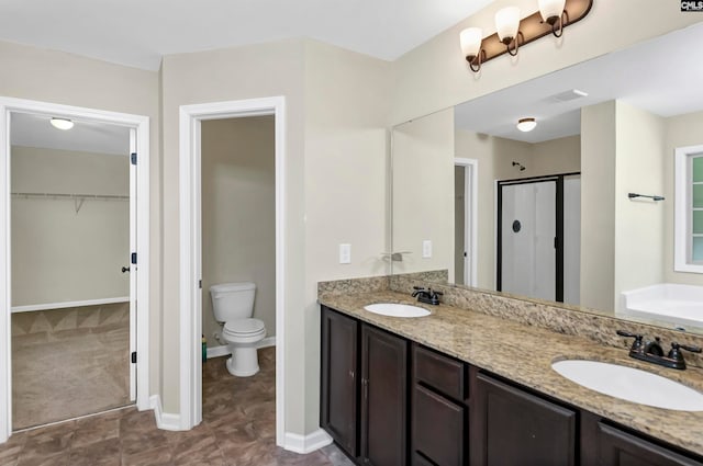 bathroom with vanity, toilet, and walk in shower