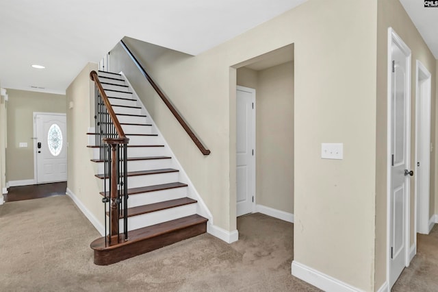 stairs featuring carpet flooring