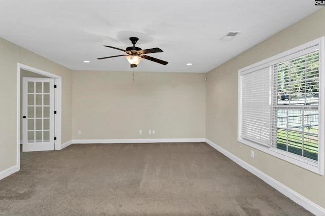 carpeted empty room featuring ceiling fan