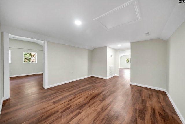 empty room with lofted ceiling and dark hardwood / wood-style floors