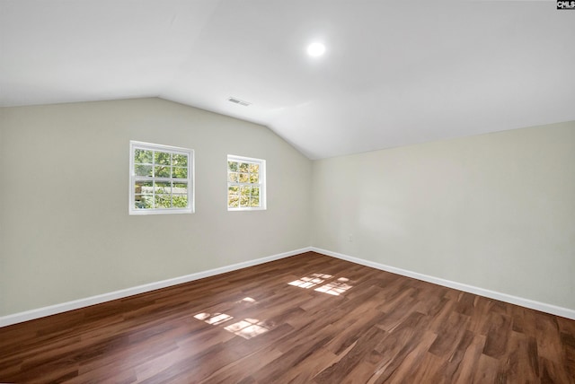 bonus room with vaulted ceiling and dark hardwood / wood-style floors