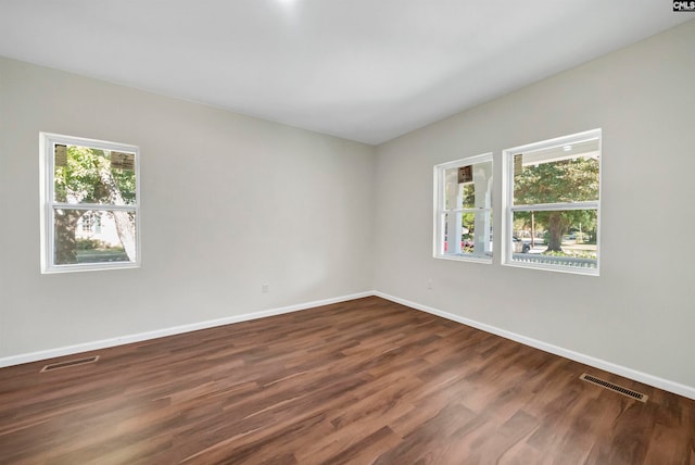 empty room featuring dark hardwood / wood-style flooring