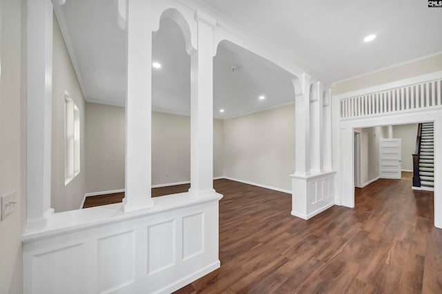 unfurnished living room with dark hardwood / wood-style floors and ornate columns