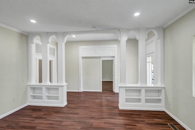 spare room with dark wood-type flooring and crown molding