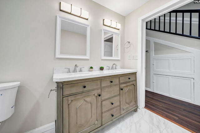 bathroom featuring vanity, wood-type flooring, and toilet