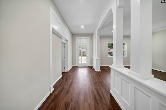 foyer with dark wood-type flooring and decorative columns