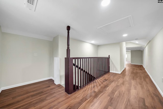 corridor with hardwood / wood-style floors