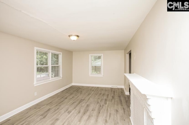 empty room featuring a healthy amount of sunlight and light wood-type flooring