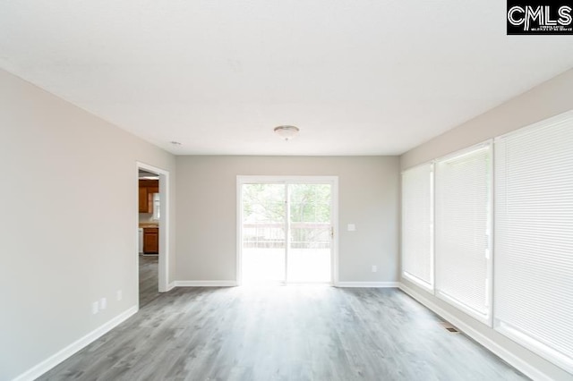 empty room with hardwood / wood-style floors