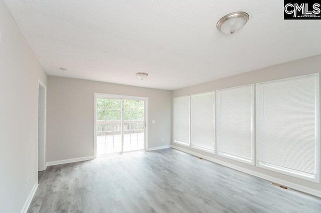 spare room with light wood-type flooring