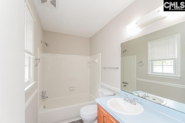 full bathroom with toilet, vanity, and tub / shower combination