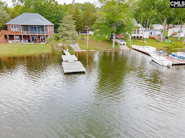 dock area with a water view and a yard