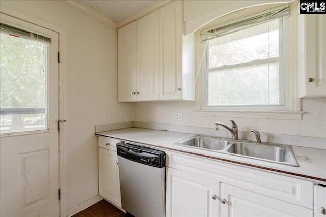 kitchen with ornamental molding, sink, stainless steel dishwasher, and white cabinets