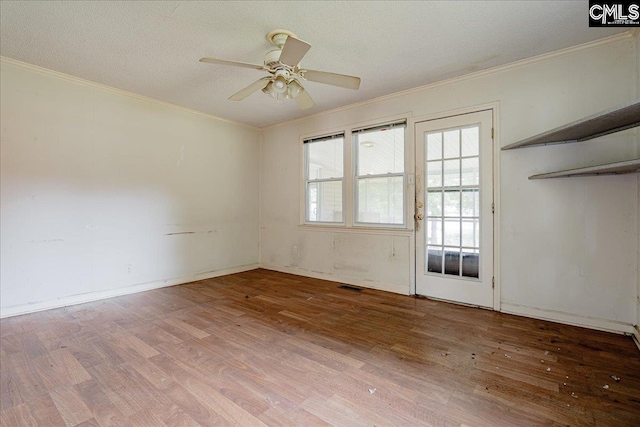 unfurnished room with ornamental molding, a textured ceiling, wood-type flooring, and ceiling fan