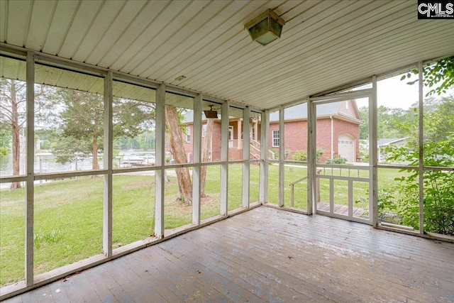 unfurnished sunroom featuring a wealth of natural light and lofted ceiling