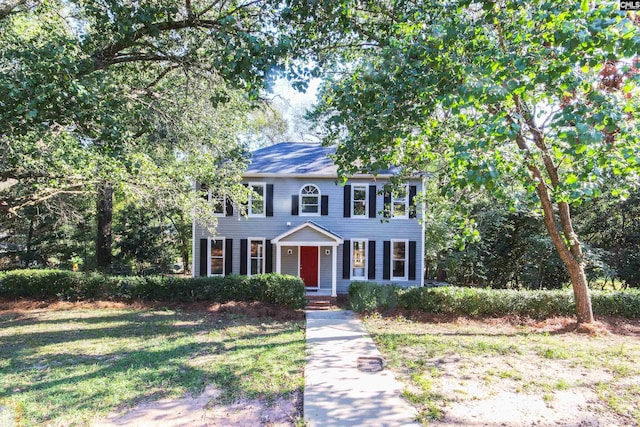 colonial home with a front lawn