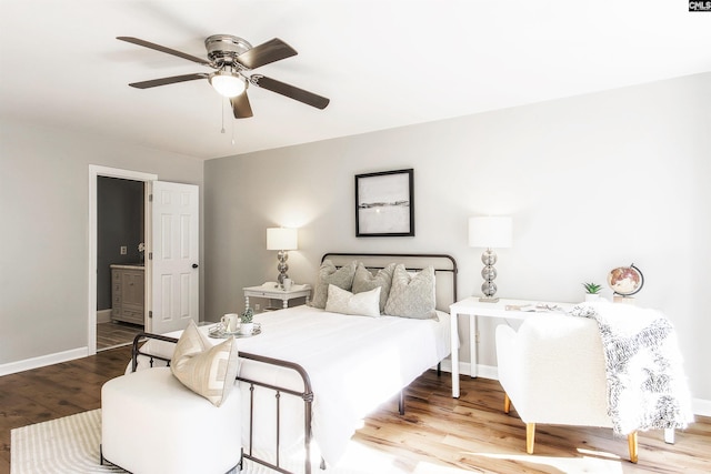 bedroom featuring ensuite bath, wood-type flooring, and ceiling fan