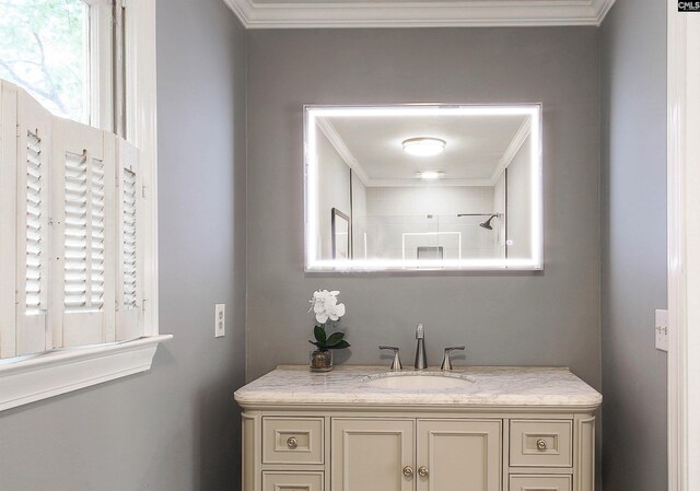 bathroom with vanity, crown molding, and a shower