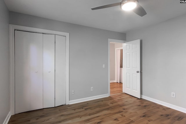 unfurnished bedroom with a closet, wood-type flooring, and ceiling fan